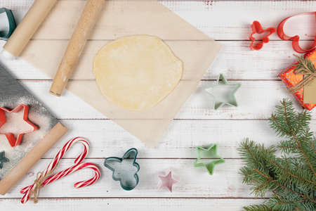 Preparing to cocking Christmas traditional gingerbread biscuit, flat lay. Concepts of tradition holiday food and New Year eve. Top view.の写真素材