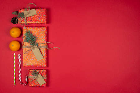 New Year and Christmas presents, handmade gift boxes wrapped with red paper and decorated fir tree...
