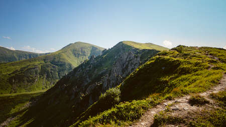 Amazing mountain landscape with blue sky with white clouds, sunny summer day in Carpathians, Ukraine. Natural outdoor travel background.の写真素材