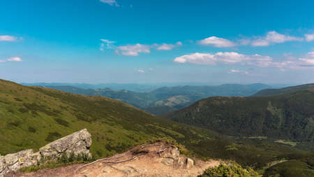 Amazing mountain landscape with blue sky with white clouds, sunny summer day in Carpathians, Ukraine. Natural outdoor travel background.の写真素材
