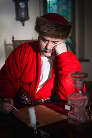 Portrait of a man in a medieval costume. Retro style and historical clothes concepts. Ukrainian Men's fashion of the 18th centuryの写真素材