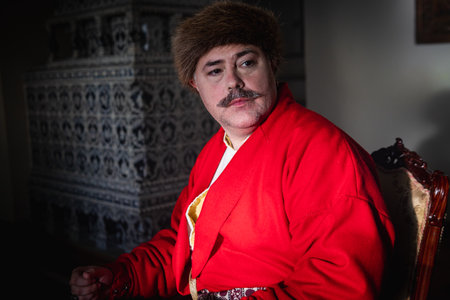 Portrait of a man in a medieval costume. Retro style and historical clothes concepts. Ukrainian Men's fashion of the 18th centuryの写真素材