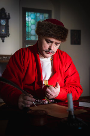 Portrait of a man in a medieval costume. Retro style and historical clothes concepts. Ukrainian Men's fashion of the 18th centuryの写真素材