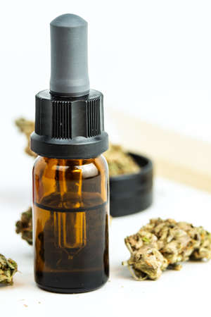 Close-up of medical marijuana buds and cannabis oil on white background. Concept of herbal and alternative medicineの写真素材
