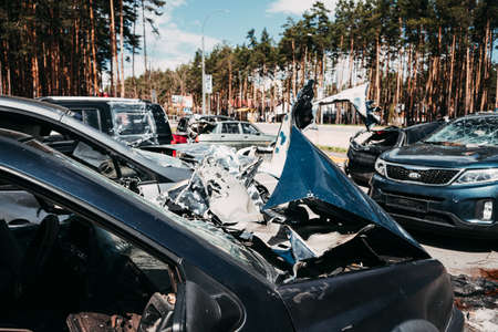 Irpin, Kyiv region, Ukraine - 28 April 2022: Car graveyard in Irpin, consequences of the invasion of the Russian army in Ukraine. Destroyed cars of civilian population.のeditorial素材