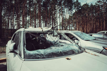 Irpin, Kyiv region, Ukraine - 28 April 2022: Car graveyard in Irpin, consequences of the invasion of the Russian army in Ukraine. Destroyed cars of civilian population.のeditorial素材