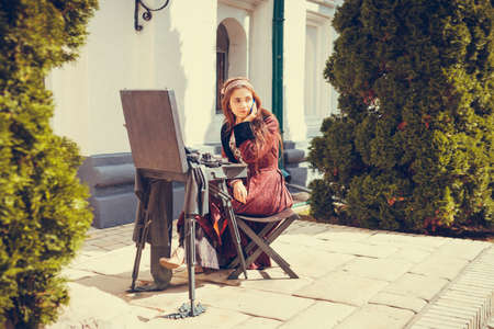 Portrait of brunette woman dressed in historical Baroque clothes with old fashion hairstyle, outdoors. middle class medieval dressの写真素材
