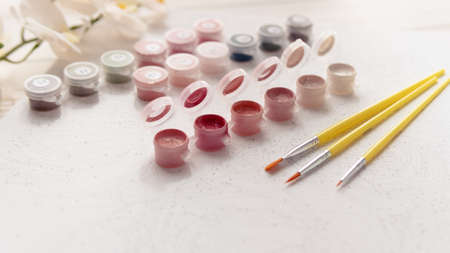 A set of colorful gouache for painting by numbers, pastel colors, drawing on canvas. Concepts of leisure activity, hobby and relax. selective focus. close up.の写真素材