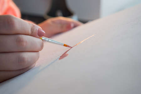 The adult woman painting by numbers, pastel colors, drawing on canvas. Concepts of leisure activity,...