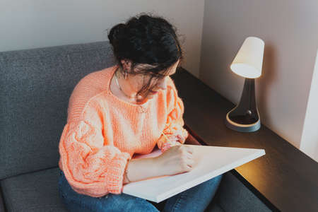 The adult woman painting by numbers, pastel colors, drawing on canvas. Concepts of leisure activity,...