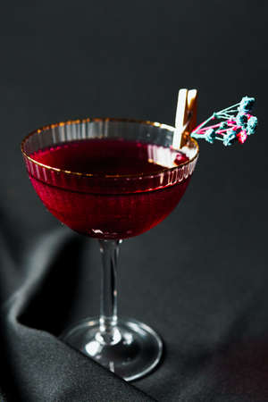 Alcoholic drink. A cocktail with elite alcohol on dark black background, close-up. Concept of nightlife and exotic drinks.の写真素材