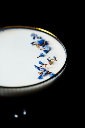 Alcoholic drink. A cocktail with elite alcohol on dark black background, close-up. Concept of nightlife and exotic drinks.の写真素材