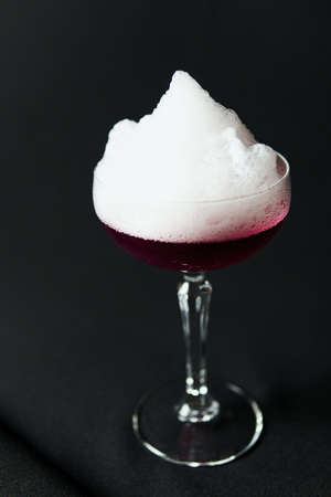 Alcoholic drink. A cocktail with elite alcohol on dark black background, close-up. Concept of...