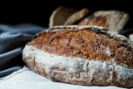 Freshly baked bread with a golden crust close up. Yeast dough. Concept of bakery products, bakery...