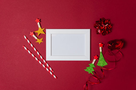 New Year and Christmas decorations on red background, flat lay. Concept of greeting card for holidaysの写真素材