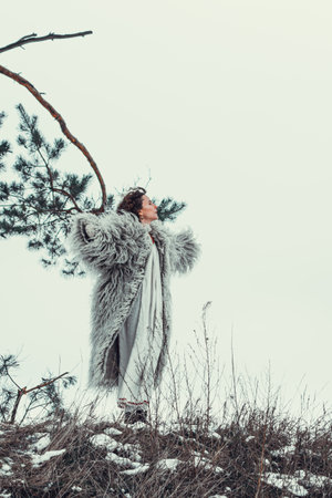 Woman in Historical Ukrainian winter clothing - gunia, sheepskin coat. Hutsul traditional winter jacketの写真素材