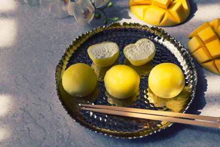 Tasty dessert Mochi with mango fruit on gray background, close up. traditional japanese rice cake dessertの写真素材