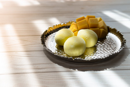 Tasty dessert Mochi with mango fruit on wooden background, close up. traditional japanese rice cake dessertの写真素材