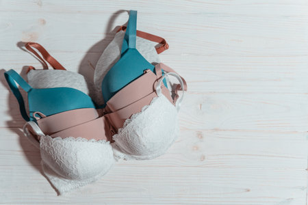 Set of colorful bras on wooden background, closeup. women's underwear. top view.の写真素材