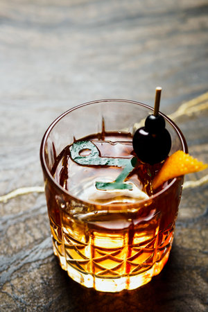 Alcoholic drink. A cocktail with elite alcohol on dark black background, close-up. Concept of...