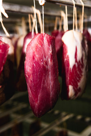 Smoked sausage production line in the factory. Pork and beef sausage salami industry. Tasty food and groceriesの写真素材