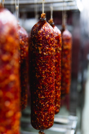Smoked sausage production line in the factory. Pork and beef sausage salami industry.の写真素材