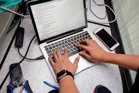 Engineer configure data center on laptop.