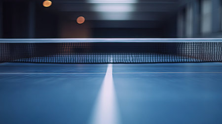Perspective view along a ping-pong table with the net in sharp focus and background fading into blurの素材