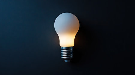 Single unlit LED bulb placed centrally on black background, highlighting its sleek design and eco-friendly lighting conceptの素材
