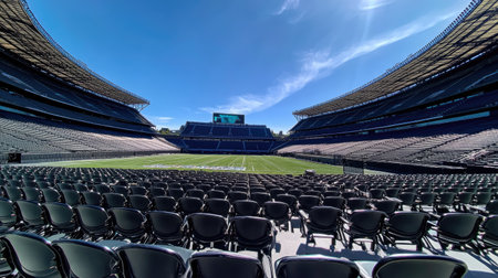 A panoramic view of empty stadium seating, with rows of empty chairs leading the eye across the vast expanse of the venueの素材