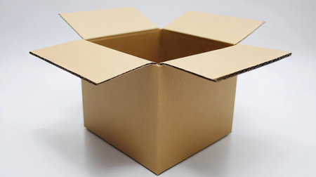 A cardboard box with the flaps folded inward, showcasing its clean and functional design on a white surfaceの素材