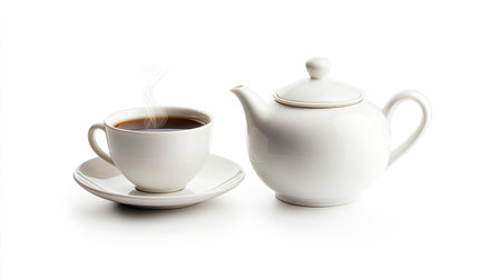 A classic white teapot and cup set filled with hot coffee, with a gentle wisp of steam rising, isolated on a white background.の素材