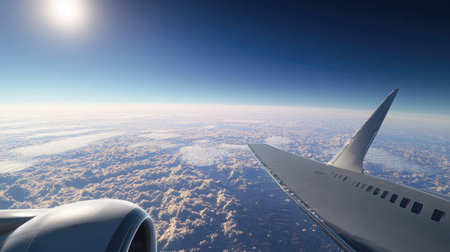 An airplane cruising at high altitude, with clear skies and a distant horizon visible in the background.の素材