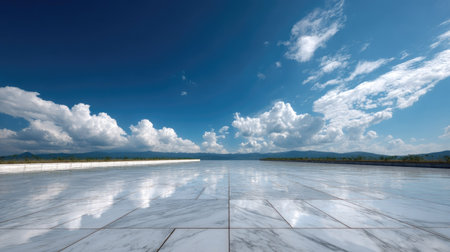Wide-angle view of a clean marble floor stretching into the distance under a vibrant blue sky with scattered cloudsの素材