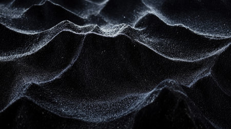 Black velvet cloth background with rich texture and gentle folds, illuminated with soft side lighting for depthの素材