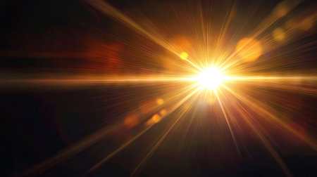 Warm natural sun flare bursting through a dark black background, creating vibrant rays and lens flare effects for dramatic lightingの素材