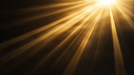 Natural sun flare effect softly diffused on a black surface, producing warm gradients and dynamic light streaksの素材