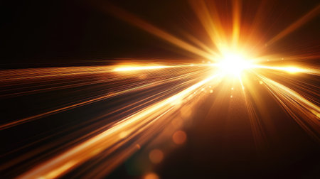 Natural sun flare effect softly diffused on a black surface, producing warm gradients and dynamic light streaksの素材
