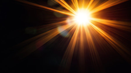 Bright sun flare with lens reflections spreading across a pure black background, ideal for creative or abstract visualsの素材