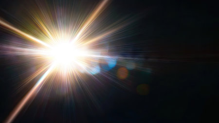 Bright sun flare with lens reflections spreading across a pure black background, ideal for creative or abstract visualsの素材