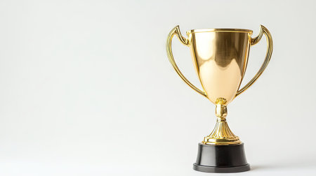 Shiny gold trophy cup isolated on a clean white background, symbolizing victory and achievement in sports or competitionsの素材