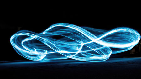 A beautiful display of glowing light streaks swirling through the darkness, creating an ethereal dance of light.の素材