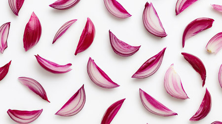 Red onion slices forming a pattern, carefully spread out on a clean white background.の素材
