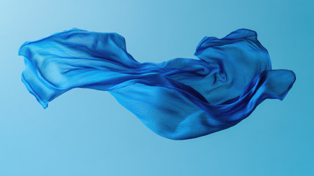 A vibrant blue t-shirt seemingly tossed into the air, captured with flowing sleeves and natural folds.の素材