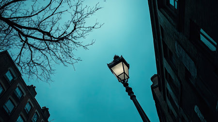 A tall street lamp photographed from ground level, with the deep blue sky creating a dramatic perspectiveの素材