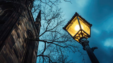 A tall street lamp photographed from ground level, with the deep blue sky creating a dramatic perspectiveの素材