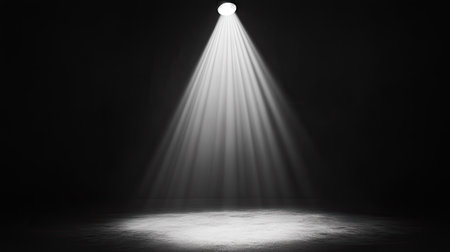 A harsh interrogation-style spotlight shining down onto a single point in a shadowy room.の素材