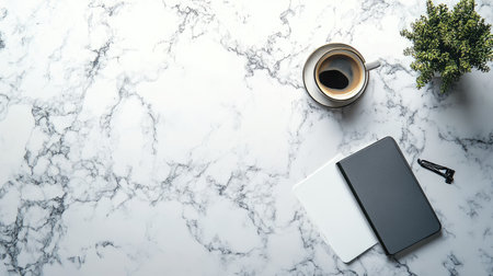 A flat-lay of a modern marble table with a phone, a notebook, and a coffee cupの素材
