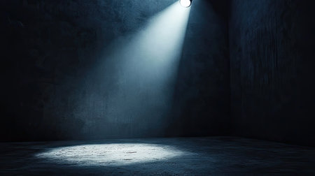 Strong directional spotlights highlighting a single object in an otherwise dark environment.の素材
