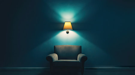 A solitary wall sconce emitting a cozy light in a dark, empty room.の素材